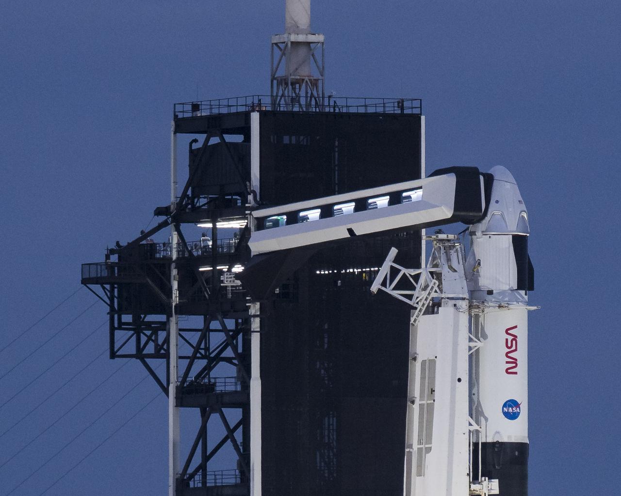 A SpaceX Falcon 9 rocket with the company's Crew Dragon spacecraft onboard is seen just before sunrise on the launch pad at Launch Complex 39A as preparations continue for the Crew-1 mission, Sunday, Nov. 15, 2020, at NASA’s Kennedy Space Center in Florida. NASA’s SpaceX Crew-1 mission is the first crew rotational mission of the SpaceX Crew Dragon spacecraft and Falcon 9 rocket to the International Space Station as part of the agency’s Commercial Crew Program. NASA astronauts Mike Hopkins, Victor Glover, and Shannon Walker, and astronaut Soichi Noguchi of the Japan Aerospace Exploration Agency (JAXA) are scheduled to launch at 7:27 p.m. EST on Sunday, Nov. 15 from Launch Complex 39A at the Kennedy Space Center. Photo Credit: (NASA/Aubrey Gemignani)