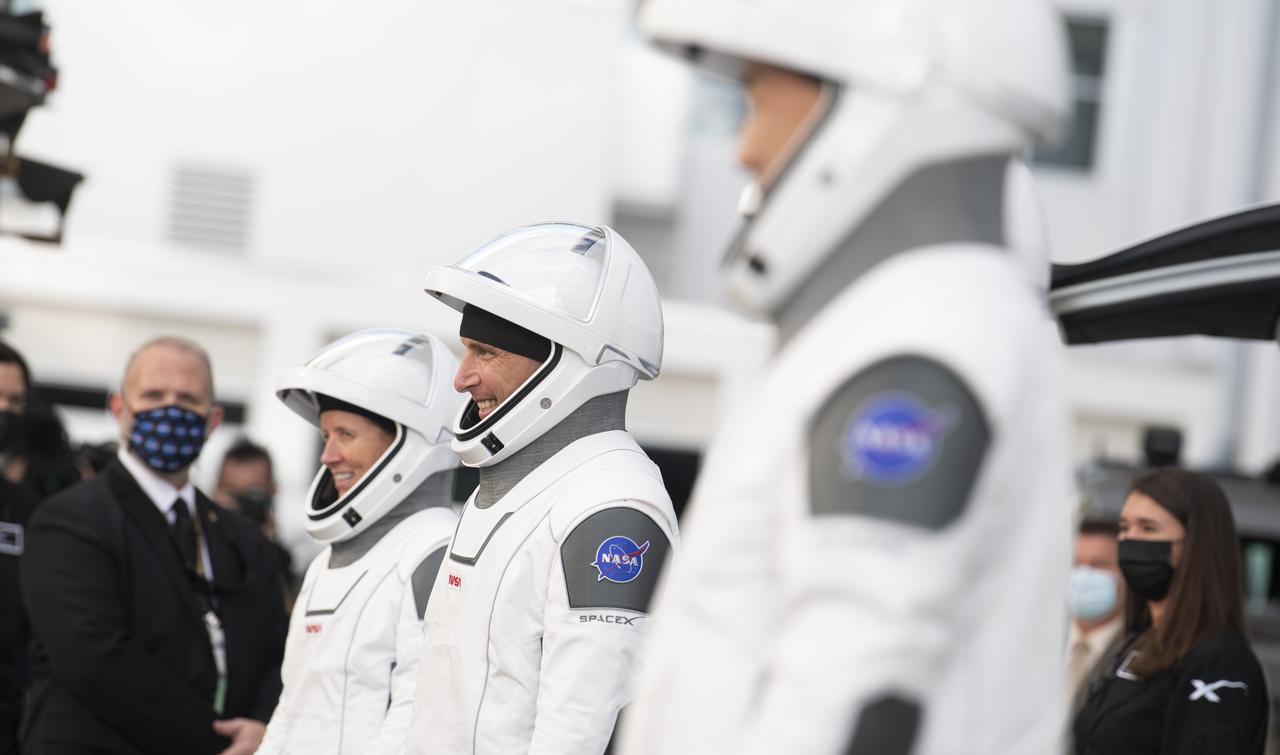 NASA astronauts Mike Hopkins, center, Shannon Walker left, and Japan Aerospace Exploration Agency (JAXA) astronaut Soichi Noguchi, right, wearing SpaceX spacesuits, are seen as they prepare to depart the Neil  A. Armstrong Operations and Checkout Building along with fellow crewmate NASA astronaut Victor Glover for Launch Complex 39A to board the SpaceX Crew Dragon spacecraft for the Crew-1 mission launch, Sunday, Nov. 15, 2020, at NASA’s Kennedy Space Center in Florida. NASA’s SpaceX Crew-1 mission is the first crew rotation mission of the SpaceX Crew Dragon spacecraft and Falcon 9 rocket to the International Space Station as part of the agency’s Commercial Crew Program. Hopkins, Glover, Walker, and Noguchi are scheduled to launch at 7:27 p.m. EST from Launch Complex 39A at the Kennedy Space Center.  Photo Credit: (NASA/Joel Kowsky)