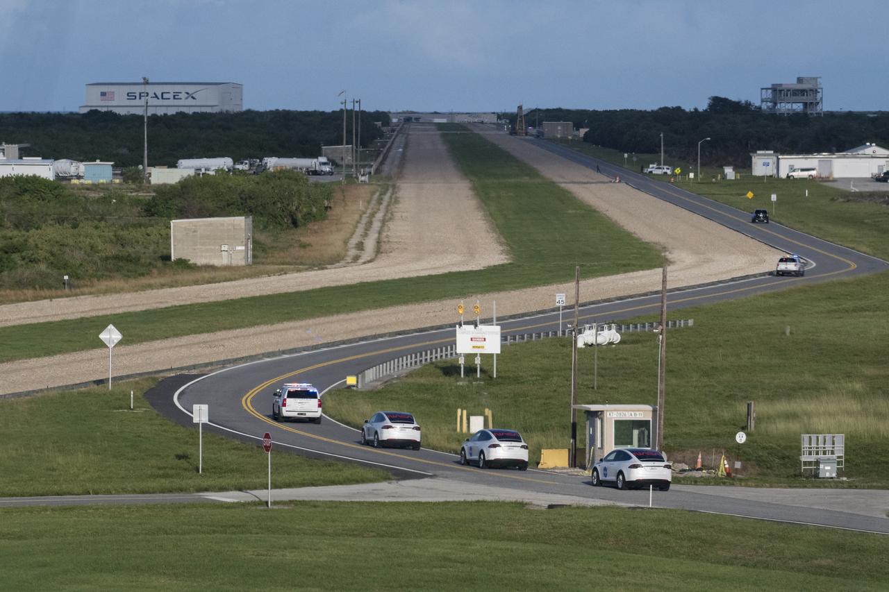 The convoy carrying NASA astronauts Mike Hopkins, Victor Glover, Shannon Walker, and Japan Aerospace Exploration Agency (JAXA) astronaut Soichi Noguchi is seen through the windows of firing room four as it makes its way to Launch Complex 39A  in preparation for the launch of a SpaceX Falcon 9 rocket carrying the company's Crew Dragon spacecraft on NASA’s SpaceX Crew-1 mission, Sunday, Nov. 15, 2020, in the Launch Control Center at NASA’s Kennedy Space Center in Florida. NASA’s SpaceX Crew-1 mission is the first crew rotation mission of the SpaceX Crew Dragon spacecraft and Falcon 9 rocket to the International Space Station as part of the agency’s Commercial Crew Program. Hopkins, Glover, Walker, and Noguchi are scheduled to launch at 7:27 p.m. EST. Photo Credit: (NASA/Aubrey Gemignani)