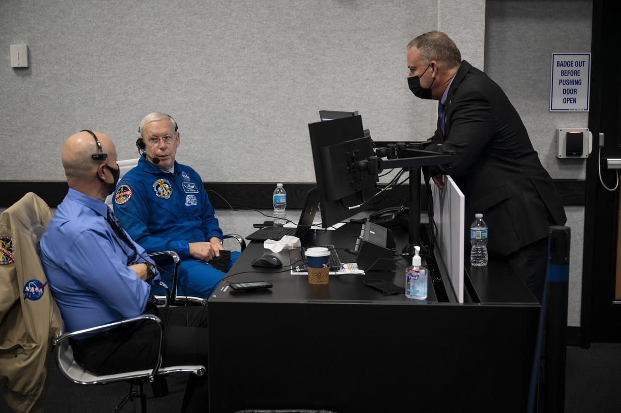 Stephen Koerner, director of the Flight Operations Directorate at NASA’s Johnson Space Center, left, and Pat Forrester, NASA’s chief of the astronaut office, center, speak with Norm Knight, deputy director of Flight Operations at NASA's Johnson Space Center as they monitor the countdown of the launch of a SpaceX Falcon 9 rocket carrying the company's Crew Dragon spacecraft on NASA’s SpaceX Crew-1 mission with NASA astronauts Mike Hopkins, Victor Glover, Shannon Walker, and Japan Aerospace Exploration Agency (JAXA) astronaut Soichi Noguchi onboard, Sunday, Nov. 15, 2020, in firing room four of the Launch Control Center at NASA’s Kennedy Space Center in Florida. NASA’s SpaceX Crew-1 mission is the first crew rotation mission of the SpaceX Crew Dragon spacecraft and Falcon 9 rocket to the International Space Station as part of the agency’s Commercial Crew Program. Hopkins, Glover, Walker, and Noguchi are scheduled to launch at 7:27 p.m. EST, from Launch Complex 39A at the Kennedy Space Center. Photo Credit: (NASA/Aubrey Gemignani)