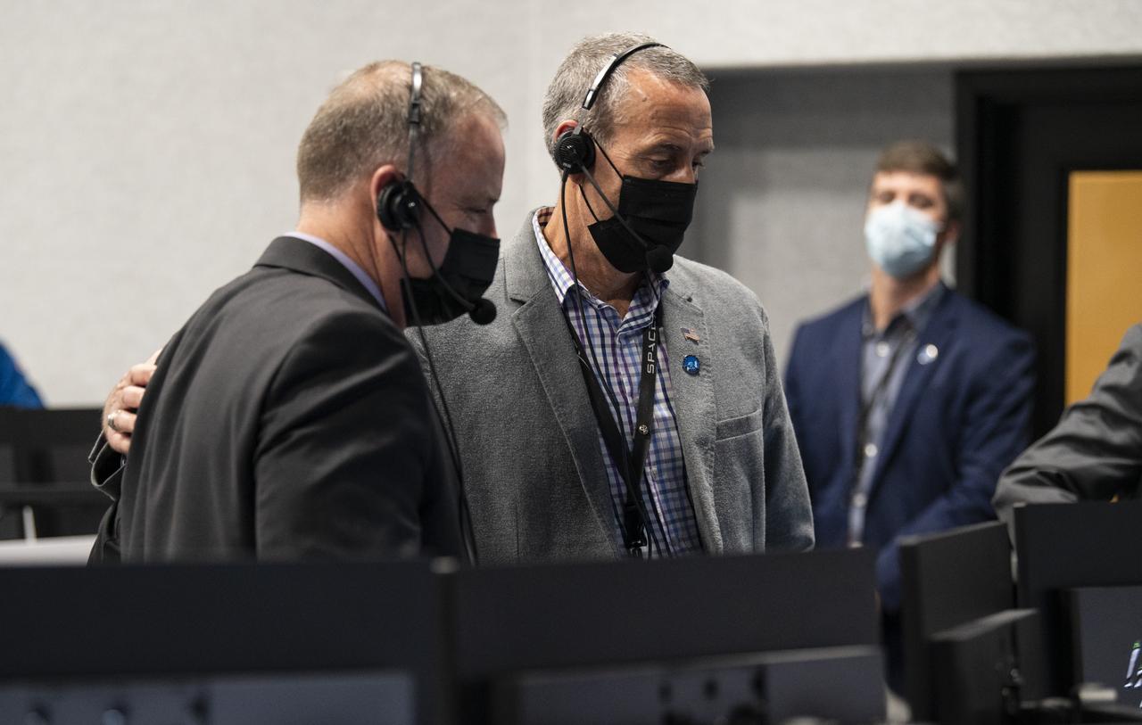 Lee Rosen, vice president, Mission and Launch Operations at SpaceX, right, pats Norm Knight, deputy director of Flight Operations at NASA's Johnson Space Center, left, on the back as they monitor the launch of a SpaceX Falcon 9 rocket carrying the company's Crew Dragon spacecraft on NASA’s SpaceX Crew-1 mission with NASA astronauts Mike Hopkins, Victor Glover, Shannon Walker, and Japan Aerospace Exploration Agency (JAXA) astronaut Soichi Noguchi onboard, Sunday, Nov. 15, 2020, in firing room four of the Launch Control Center at NASA’s Kennedy Space Center in Florida. NASA’s SpaceX Crew-1 mission is the first crew rotation mission of the SpaceX Crew Dragon spacecraft and Falcon 9 rocket to the International Space Station as part of the agency’s Commercial Crew Program. Hopkins, Glover, Walker, and Noguchi launched at 7:27 p.m. EST, from Launch Complex 39A at the Kennedy Space Center. Photo Credit: (NASA/Aubrey Gemignani)