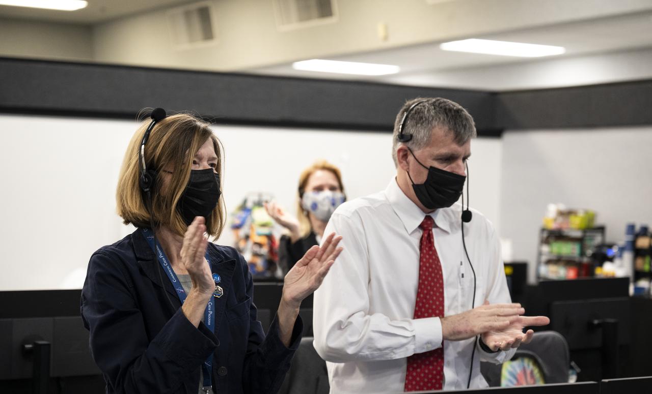 Kathy Lueders, Associate Administrator of the Human Exploration and Operations Mission Directorate, left; Steve Stich, program manager for NASA's Commercial Crew Program, clap after the launch of a SpaceX Falcon 9 rocket carrying the company's Crew Dragon spacecraft on NASA’s SpaceX Crew-1 mission with NASA astronauts Mike Hopkins, Victor Glover, Shannon Walker, and Japan Aerospace Exploration Agency (JAXA) astronaut Soichi Noguchi onboard, Sunday, Nov. 15, 2020, in firing room four of the Launch Control Center at NASA’s Kennedy Space Center in Florida. NASA’s SpaceX Crew-1 mission is the first crew rotation mission of the SpaceX Crew Dragon spacecraft and Falcon 9 rocket to the International Space Station as part of the agency’s Commercial Crew Program. Hopkins, Glover, Walker, and Noguchi launched at 7:27 p.m. EST, from Launch Complex 39A at the Kennedy Space Center. Photo Credit: (NASA/Aubrey Gemignani)