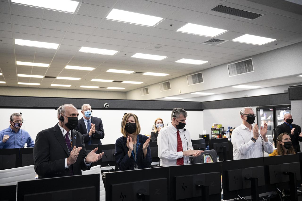NASA and SpaceX managers applaud after the launch of a SpaceX Falcon 9 rocket carrying the company's Crew Dragon spacecraft on NASA’s SpaceX Crew-1 mission with NASA astronauts Mike Hopkins, Victor Glover, Shannon Walker, and Japan Aerospace Exploration Agency (JAXA) astronaut Soichi Noguchi onboard, Sunday, Nov. 15, 2020, in firing room four of the Launch Control Center at NASA’s Kennedy Space Center in Florida. NASA’s SpaceX Crew-1 mission is the first crew rotation mission of the SpaceX Crew Dragon spacecraft and Falcon 9 rocket to the International Space Station as part of the agency’s Commercial Crew Program. Hopkins, Glover, Walker, and Noguchi launched at 7:27 p.m. EST, from Launch Complex 39A at the Kennedy Space Center. Photo Credit: (NASA/Aubrey Gemignani)