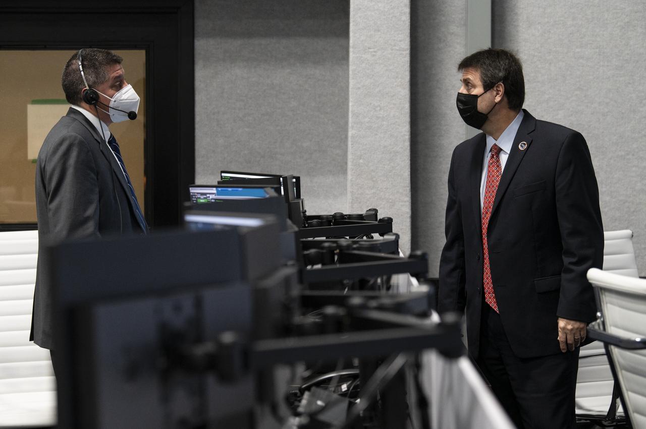 Richard Jones, manager, NASA Mission Management and Integration Office, Commercial Crew Program, left, speaks with Joel Montalbano, NASA’s International Space Station deputy program manager, after the launch of a SpaceX Falcon 9 rocket carrying the company's Crew Dragon spacecraft on NASA’s SpaceX Crew-1 mission with NASA astronauts Mike Hopkins, Victor Glover, Shannon Walker, and Japan Aerospace Exploration Agency (JAXA) astronaut Soichi Noguchi onboard, Sunday, Nov. 15, 2020, in firing room four of the Launch Control Center at NASA’s Kennedy Space Center in Florida. NASA’s SpaceX Crew-1 mission is the first crew rotation mission of the SpaceX Crew Dragon spacecraft and Falcon 9 rocket to the International Space Station as part of the agency’s Commercial Crew Program. Hopkins, Glover, Walker, and Noguchi launched at 7:27 p.m. EST, from Launch Complex 39A at the Kennedy Space Center. Photo Credit: (NASA/Aubrey Gemignani)