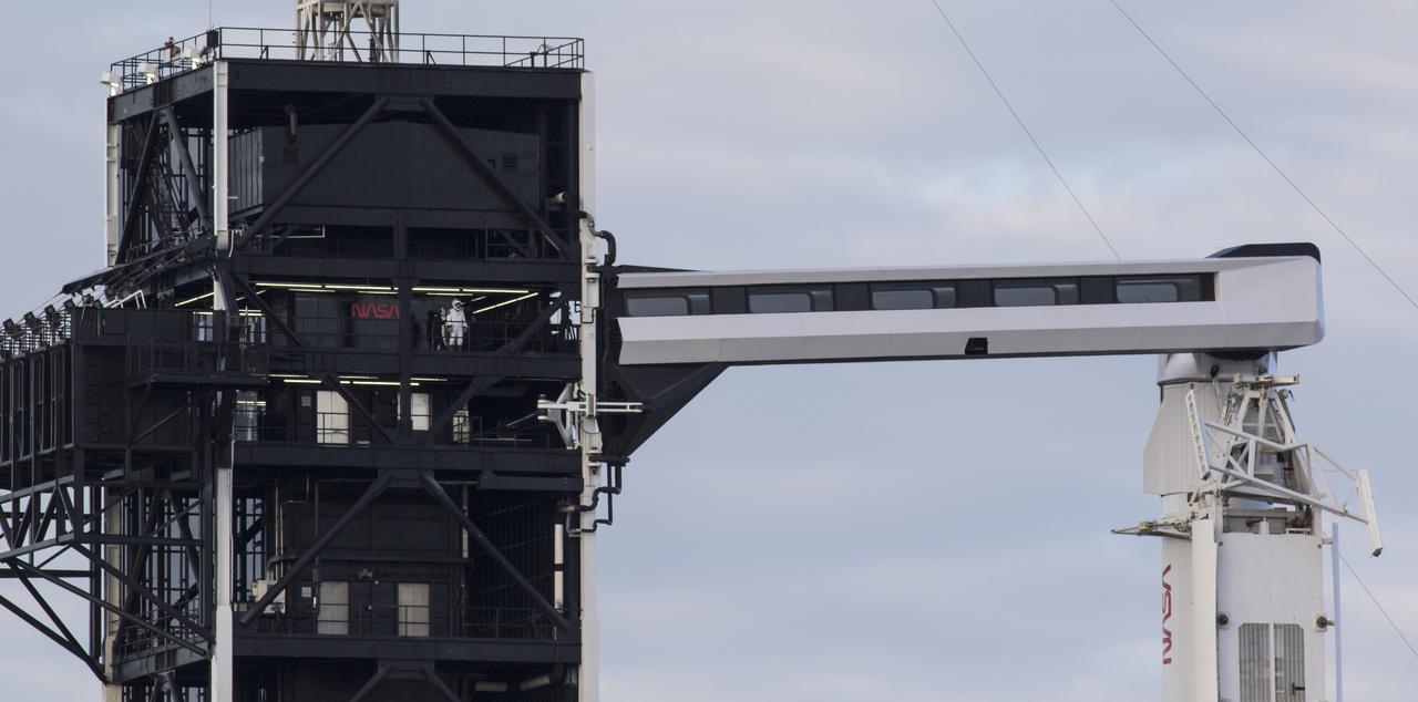 NASA astronaut Mike Hopkins is seen on the fixed service structure of Launch Complex 39A before boarding SpaceX’s Crew Dragon spacecraft atop the company’s Falcon 9 rocket before the launch of NASA’s SpaceX Crew-1 mission, Sunday, Nov. 15, 2020, at NASA’s Kennedy Space Center in Florida. NASA’s SpaceX Crew-1 mission is the first crew rotation mission of the SpaceX Crew Dragon spacecraft and Falcon 9 rocket to the International Space Station as part of the agency’s Commercial Crew Program. Hopkins, and fellow NASA astronauts Victor Glover, Shannon Walker, and Japan Aerospace Exploration Agency (JAXA) astronaut Soichi Noguchi launched at 7:27 p.m. EST from Launch Complex 39A at the Kennedy Space Center to begin a six month mission onboard the orbital outpost. Photo Credit: (NASA/Joel Kowsky)