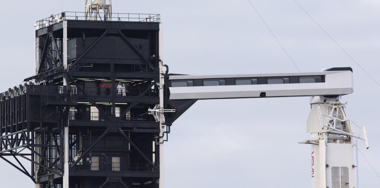 NASA astronaut Victor Glover and Japan Aerospace Exploration Agency (JAXA) astronaut Soichi Noguchi are seen on the fixed service structure of Launch Complex 39A before boarding SpaceX’s Crew Dragon spacecraft atop the company’s Falcon 9 rocket before the launch of NASA’s SpaceX Crew-1 mission, Sunday, Nov. 15, 2020, at NASA’s Kennedy Space Center in Florida. NASA’s SpaceX Crew-1 mission is the first crew rotation mission of the SpaceX Crew Dragon spacecraft and Falcon 9 rocket to the International Space Station as part of the agency’s Commercial Crew Program. Glover, Noguchi, and NASA astronauts Shannon Walker and Mike Hopkins launched at 7:27 p.m. EST from Launch Complex 39A at the Kennedy Space Center to begin a six month mission onboard the orbital outpost. Photo Credit: (NASA/Joel Kowsky)