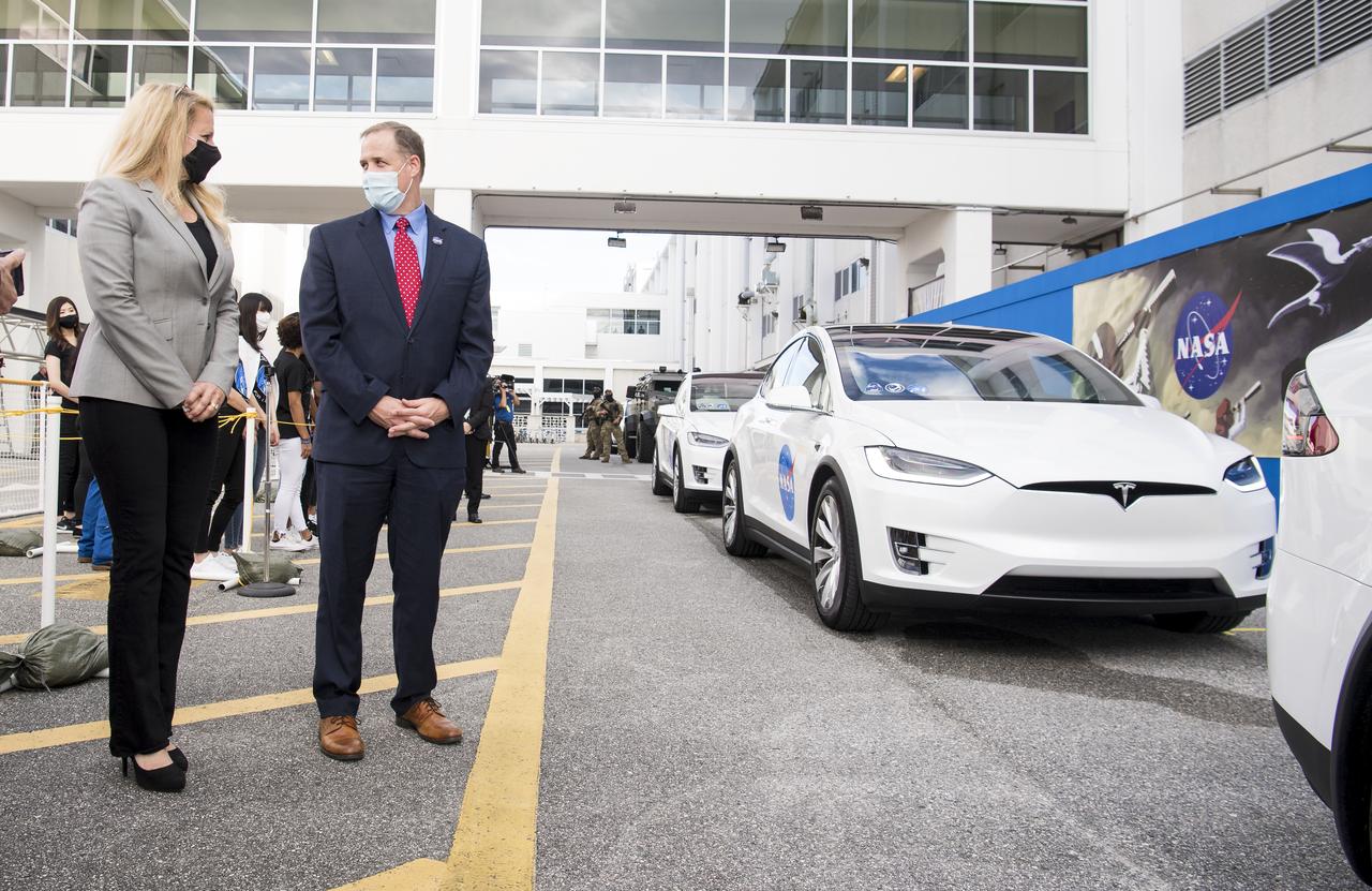 Gwynne Shotwell, president and chief operating officer of SpaceX, left, and NASA Administrator Jim Bridenstine, right, are seen as they wait to see NASA astronauts Mike Hopkins, Victor Glover, Shannon Walker, and Japan Aerospace Exploration Agency (JAXA) astronaut Soichi Noguchi, depart the Neil  A. Armstrong Operations and Checkout Building for Launch Complex 39A to board the SpaceX Crew Dragon spacecraft for the Crew-1 mission launch Sunday, Nov. 15, 2020, at NASA’s Kennedy Space Center in Florida. NASA’s SpaceX Crew-1 mission is the first crew rotation mission of the SpaceX Crew Dragon spacecraft and Falcon 9 rocket to the International Space Station as part of the agency’s Commercial Crew Program. Hopkins, Glover, Walker, and Noguchi launched at 7:27 p.m. EST on Sunday, Nov. 15, from Launch Complex 39A at the Kennedy Space Center.  Photo Credit: (NASA/Joel Kowsky)