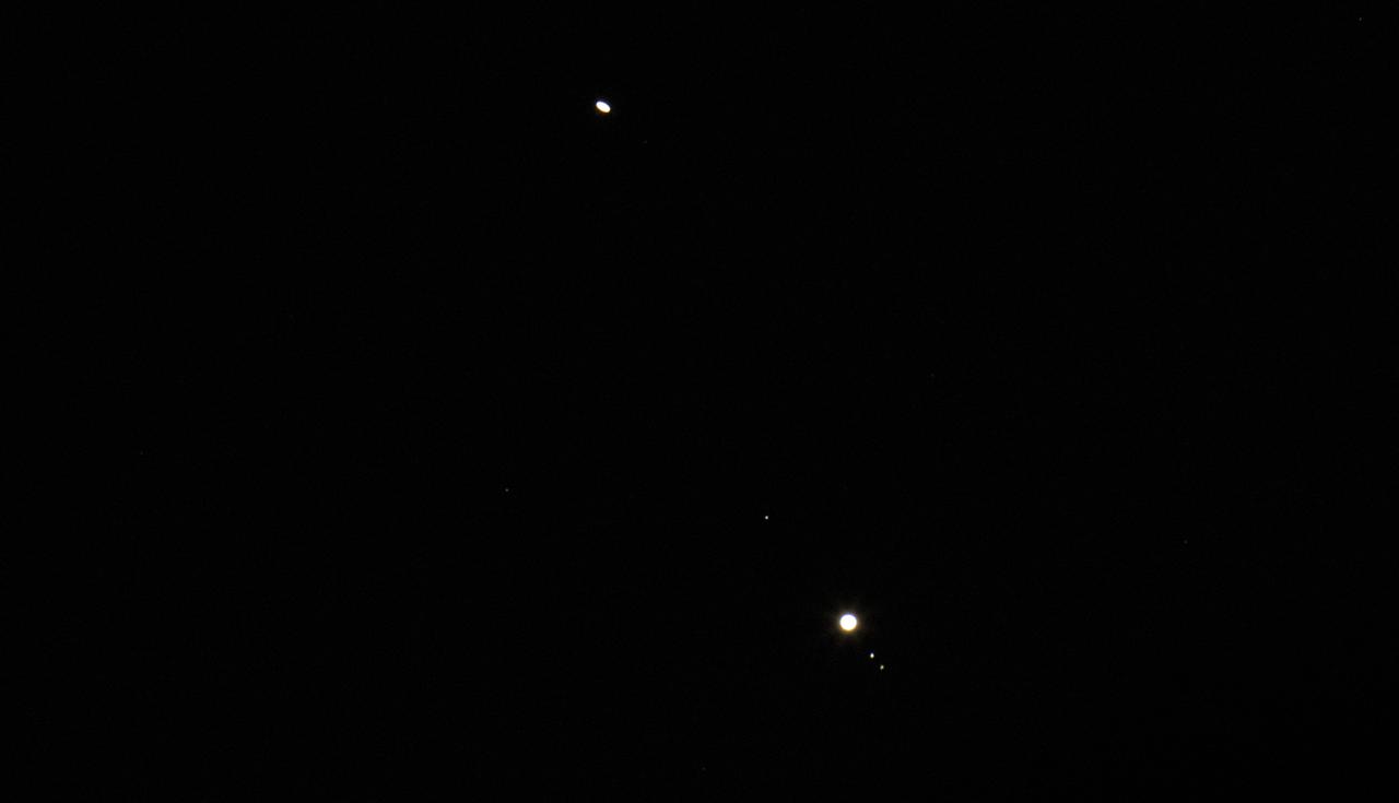 Saturn, top, and Jupiter, bottom, are seen after sunset from Alexandria, Va., Thursday, Dec. 17, 2020. The two planets are drawing closer to each other in the sky as they head towards a “great conjunction” on December 21, where the two giant planets will appear a tenth of a degree apart. Photo Credit: (NASA/Joel Kowsky)