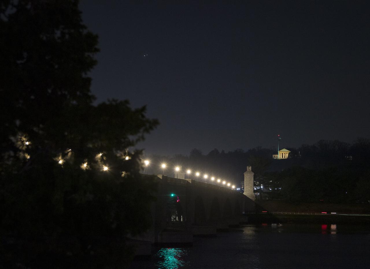 Jupiter, left, and Saturn, right, are seen during the “great conjunction” where the two planets appear a tenth of a degree apart from one another, Monday, Dec. 21, 2020, from Washington, DC. Photo Credit: (NASA/Aubrey Gemignani)
