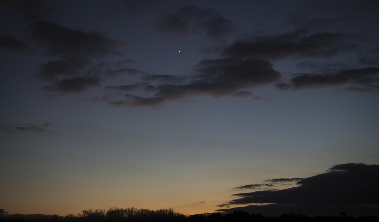 Jupiter, left, and Saturn, right, are seen after sunset from Washington, DC, Tuesday, Dec. 22, 2020. The two planets are now slowly separating from each other in the sky, after appearing a tenth of a degree apart during the "great conjunction" on December 21. Photo Credit: (NASA/Aubrey Gemignani)