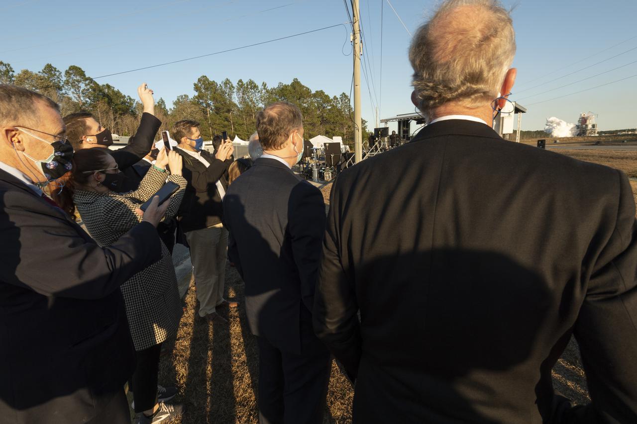 NASA Administrator Jim Bridenstine, 2nd from right, and NASA Deputy Administrator Jim Morhard, left, along with other guest watch as the core stage for the first flight of NASA’s Space Launch System rocket undergoes a scheduled eight minute duration hot fire test in the B-2 Test Stand, Saturday, Jan. 16, 2021, at NASA’s Stennis Space Center near Bay St. Louis, Mississippi. The four RS-25 engines fired for a little more than one minute and generated 1.6 million pounds of thrust. The hot fire is the final test of the Green Run test series, a comprehensive assessment of the Space Launch System’s core stage prior to launching the Artemis I mission to the Moon. Photo Credit: (NASA/Robert Markowitz)