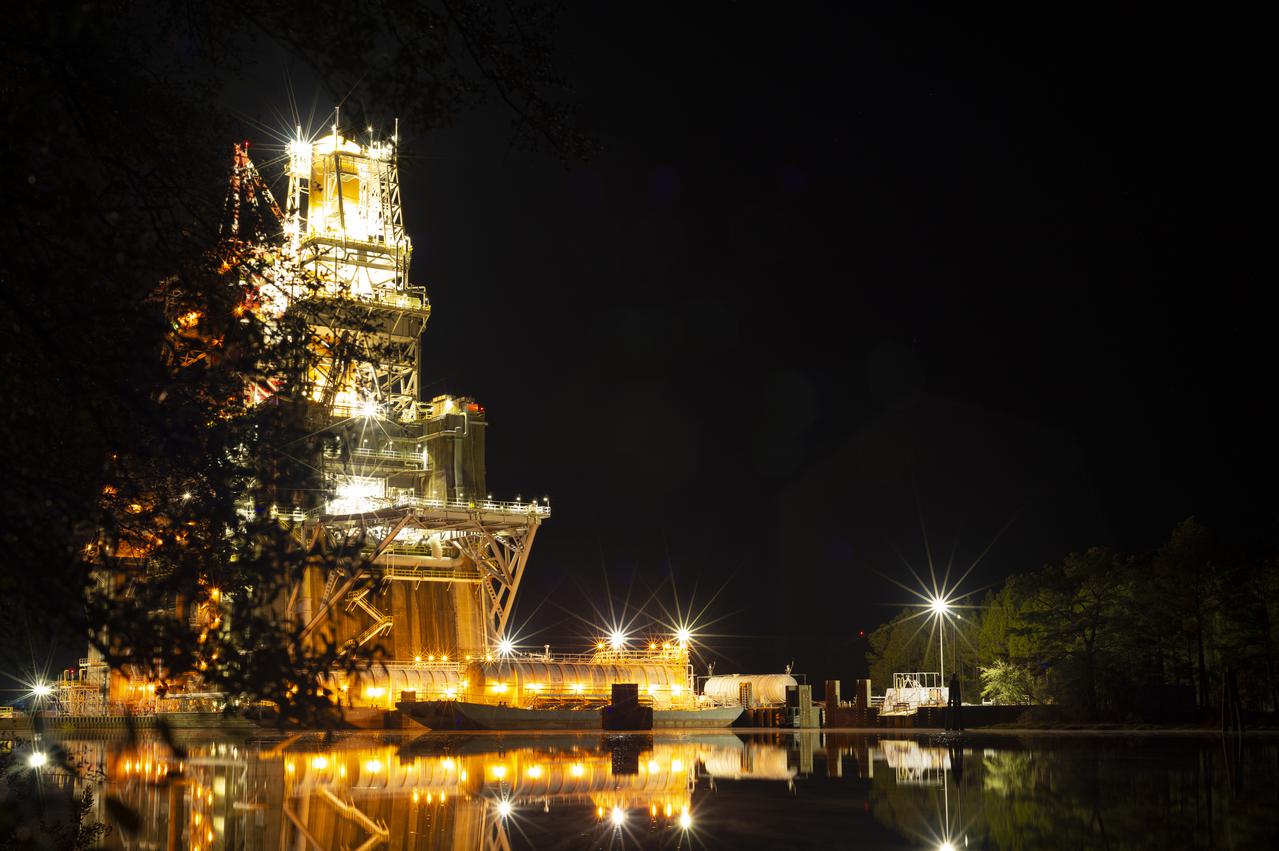 The B-2 Test Stand with the core stage for the first flight of NASA’s Space Launch System rocket is seen in later in the evening after a hot fire test, Saturday, Jan. 16, 2021, at NASA’s Stennis Space Center near Bay St. Louis, Mississippi. The four RS-25 engines fired for a little more than one minute and generated 1.6 million pounds of thrust. The hot fire is the final test of the Green Run test series, a comprehensive assessment of the Space Launch System’s core stage prior to launching the Artemis I mission to the Moon.  Photo Credit: (NASA/Robert Markowitz)