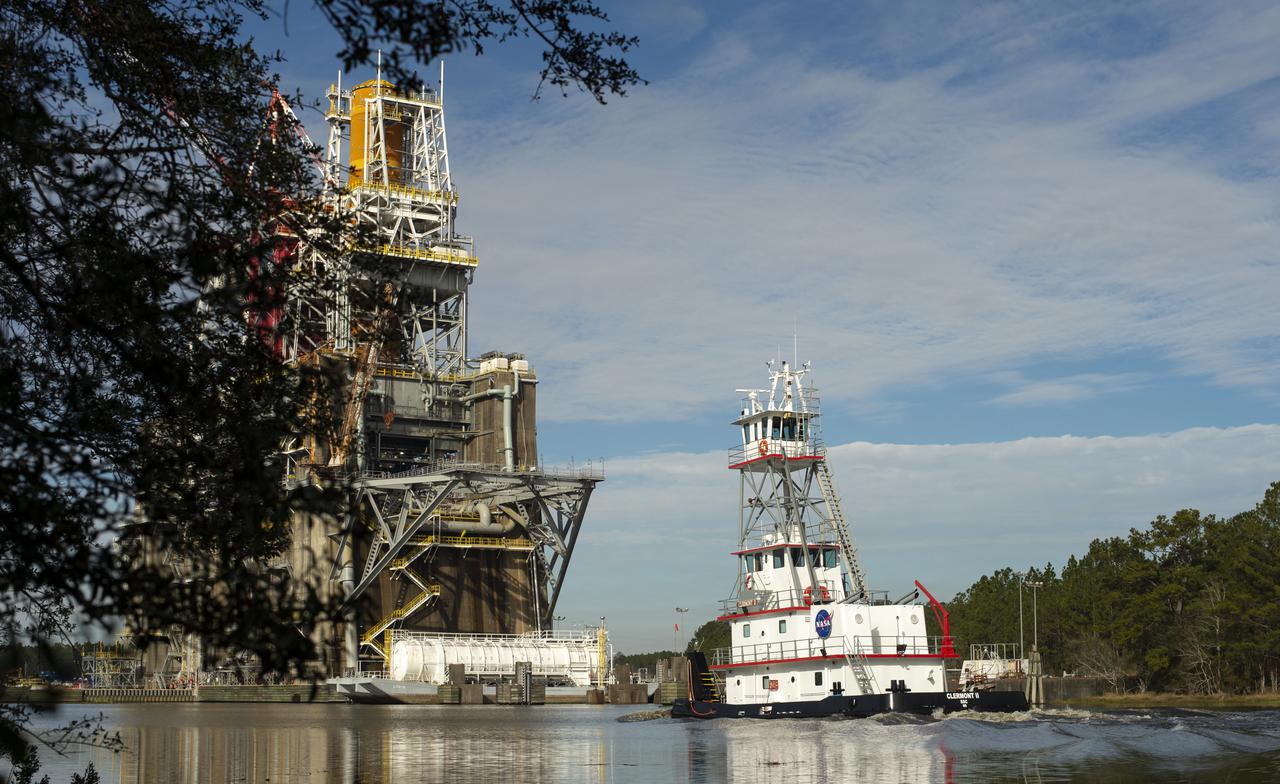 NASA tugboat Clermont II arrives at the B-2 Test Stand the day after a hot fire test of the core stage for the first flight of NASA’s Space Launch System rocket, Saturday, Jan. 16, 2021, at NASA’s Stennis Space Center near Bay St. Louis, Mississippi. During the test the four RS-25 engines fired for a little more than one minute and generated 1.6 million pounds of thrust. The hot fire is the final test of the Green Run test series, a comprehensive assessment of the Space Launch System’s core stage prior to launching the Artemis I mission to the Moon.  Photo Credit: (NASA/Robert Markowitz)