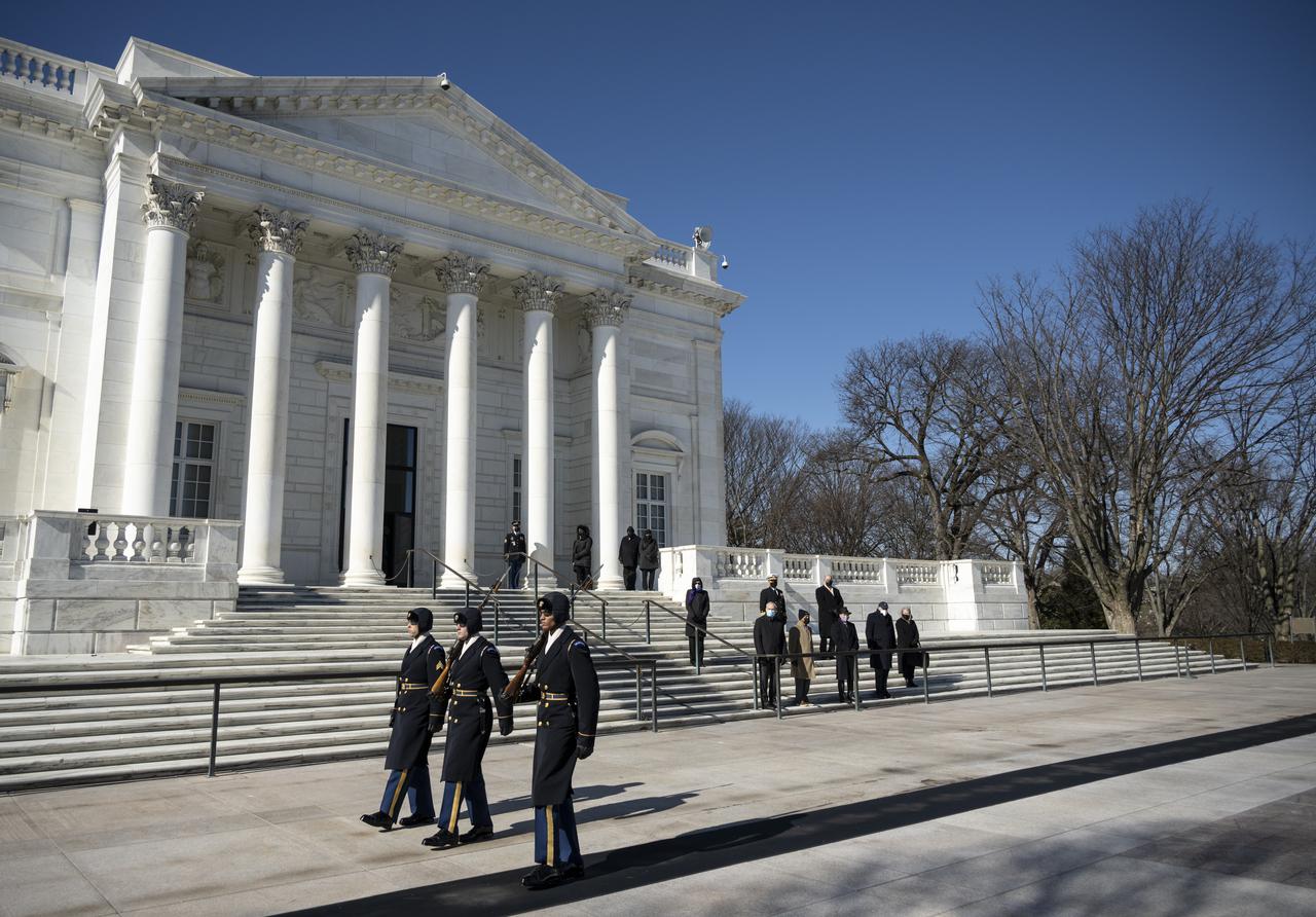 NASA personnel watch the guard-change ceremony at the Tomb of the Unknowns by as part of NASA's Day of Remembrance, Thursday, Jan. 28, 2021, at Arlington National Cemetery in Arlington, Va.  Wreaths were laid in memory of those men and women who lost their lives in the quest for space exploration.  Photo Credit: (NASA/Bill Ingalls)