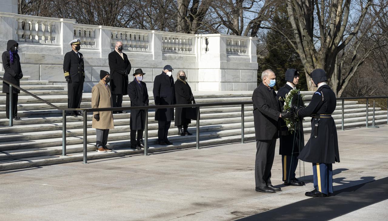 NASA personnel watch as a wreath is laid at the Tomb of the Unknowns by acting NASA Administrator Steve Jurczyk as part of NASA's Day of Remembrance, Thursday, Jan. 28, 2021, at Arlington National Cemetery in Arlington, Va.  The wreaths were laid in memory of those men and women who lost their lives in the quest for space exploration.  Photo Credit: (NASA/Bill Ingalls)