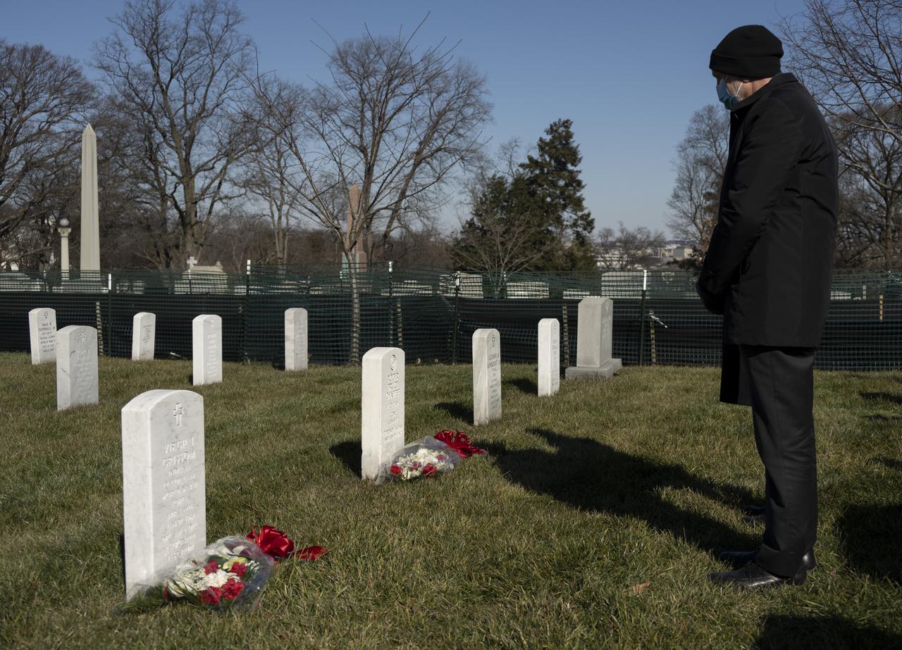 The grave markers of Virgil "Gus" Grissom, foreground, and Roger Chaffee, from Apollo 1, are seen as acting NASA Administrator Steve Jurczyk pays respects during a ceremony that was part of NASA's Day of Remembrance, Thursday, Jan. 28, 2021, at Arlington National Cemetery in Arlington, Va.  Wreaths were laid in memory of those men and women who lost their lives in the quest for space exploration.  Photo Credit: (NASA/Bill Ingalls)