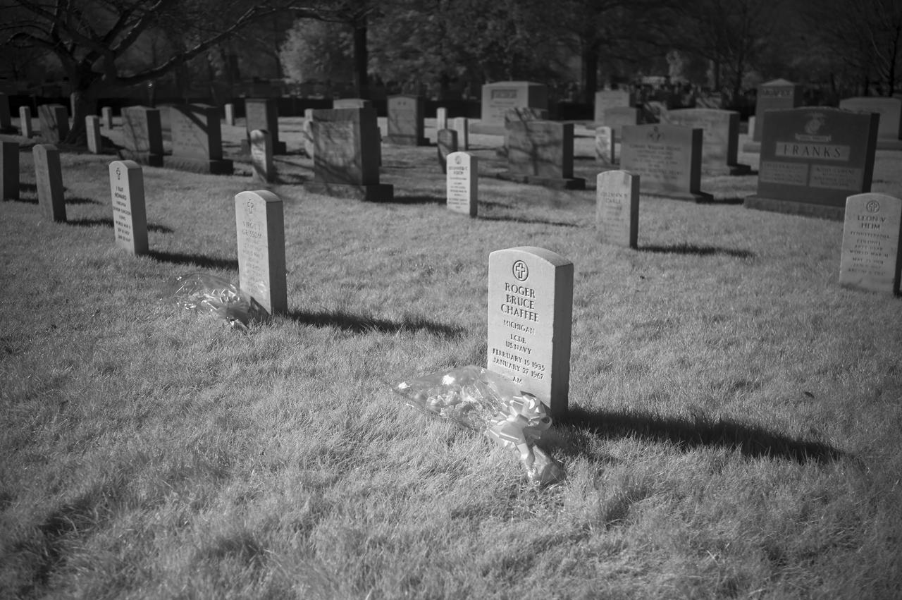 The grave markers of Roger Chaffee, and Virgil "Gus" Grissom and from Apollo 1, are seen in this black and white infrared photograph after a wreath laying ceremony that was part of NASA's Day of Remembrance, Thursday, Jan. 28, 2021, at Arlington National Cemetery in Arlington, Va.  Wreaths were laid in memory of those men and women who lost their lives in the quest for space exploration.  Photo Credit: (NASA/Bill Ingalls)