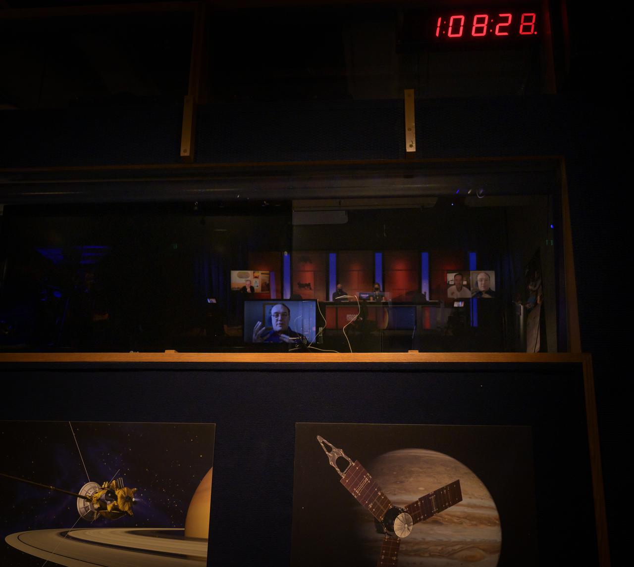 Mission managers and scientist are seen reflected in the television control room window during a NASA Perseverance rover mission science overview, Tuesday, Feb. 16, 2021, at NASA's Jet Propulsion Laboratory in Pasadena, California. The Perseverance Mars rover is due to land on Mars Thursday, Feb. 18, 2021. A key objective for Perseverance’s mission on Mars is astrobiology, including the search for signs of ancient microbial life. The rover will characterize the planet’s geology and past climate, pave the way for human exploration of the Red Planet, and be the first mission to collect and cache Martian rock and regolith. Photo Credit: (NASA/Bill Ingalls)