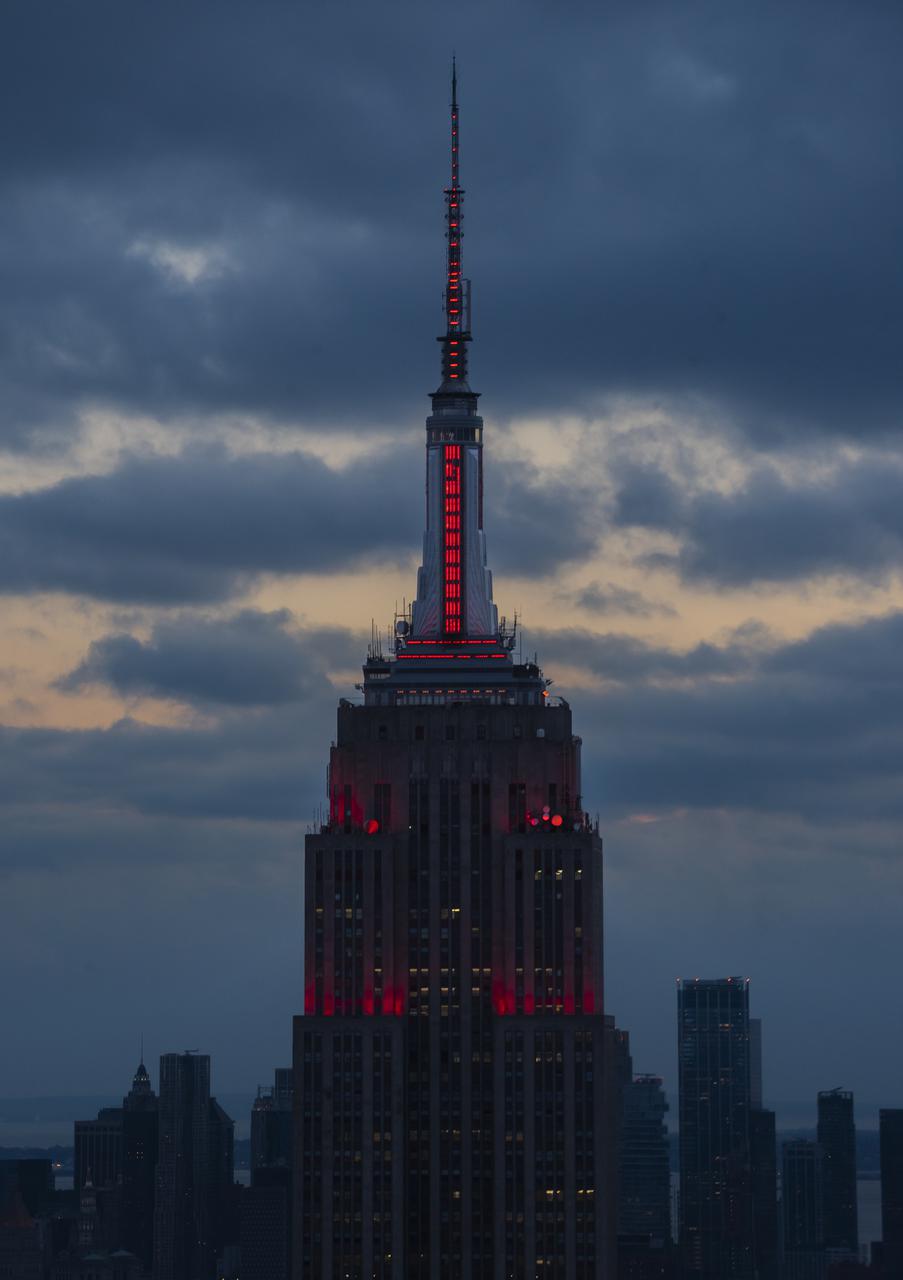 The Empire State Building is illuminated in red to celebrate this Thursday's scheduled landing on Mars of NASA's Perseverance rover, Tuesday, Feb. 16, 2021 in New York City. A key objective for Perseverance’s mission on Mars is astrobiology, including the search for signs of ancient microbial life. The rover will characterize the planet’s geology and past climate, pave the way for human exploration of the Red Planet, and be the first mission to collect and cache Martian rock and regolith. Photo Credit: (NASA/Emma Howells)