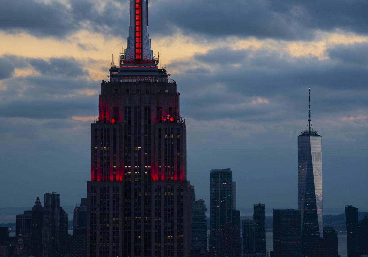 The Empire State Building is illuminated in red to celebrate this Thursday's scheduled landing on Mars of NASA's Perseverance rover, Tuesday, Feb. 16, 2021 in New York City. A key objective for Perseverance’s mission on Mars is astrobiology, including the search for signs of ancient microbial life. The rover will characterize the planet’s geology and past climate, pave the way for human exploration of the Red Planet, and be the first mission to collect and cache Martian rock and regolith. Photo Credit: (NASA/Emma Howells)