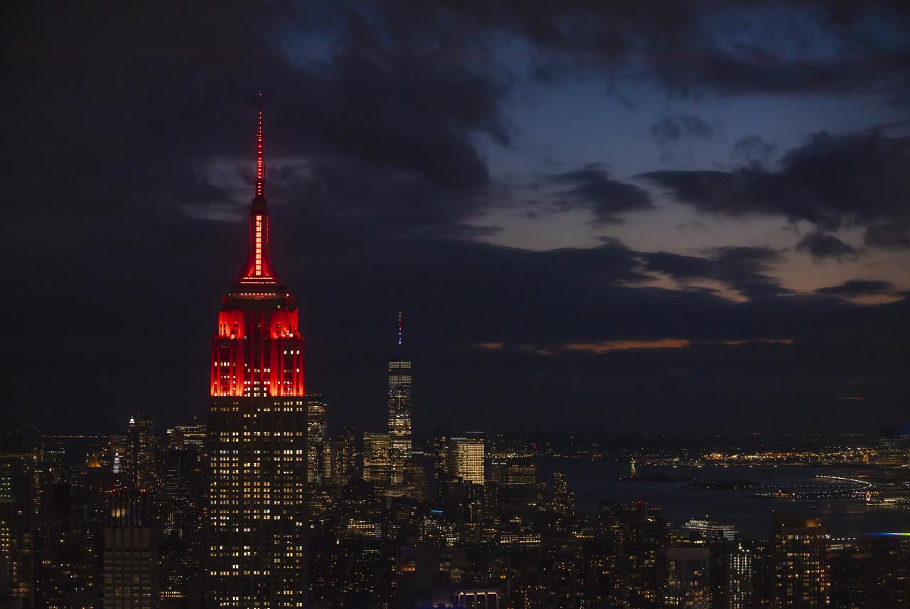 The Empire State Building is illuminated in red to celebrate this Thursday's scheduled landing on Mars of NASA's Perseverance rover, Tuesday, Feb. 16, 2021 in New York City. A key objective for Perseverance’s mission on Mars is astrobiology, including the search for signs of ancient microbial life. The rover will characterize the planet’s geology and past climate, pave the way for human exploration of the Red Planet, and be the first mission to collect and cache Martian rock and regolith. Photo Credit: (NASA/Emma Howells)