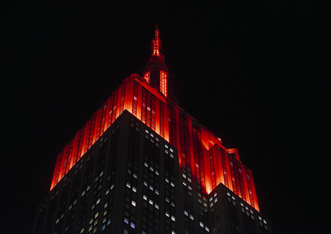 The Empire State Building is illuminated in red to celebrate this Thursday's scheduled landing on Mars of NASA's Perseverance rover, Tuesday, Feb. 16, 2021 in New York City. A key objective for Perseverance’s mission on Mars is astrobiology, including the search for signs of ancient microbial life. The rover will characterize the planet’s geology and past climate, pave the way for human exploration of the Red Planet, and be the first mission to collect and cache Martian rock and regolith. Photo Credit: (NASA/Emma Howells)