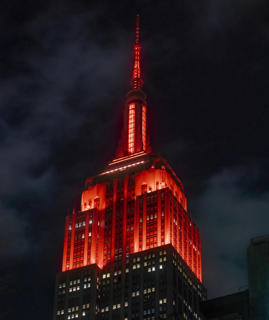 The Empire State Building is illuminated in red to celebrate this Thursday's scheduled landing on Mars of NASA's Perseverance rover, Tuesday, Feb. 16, 2021 in New York City. A key objective for Perseverance’s mission on Mars is astrobiology, including the search for signs of ancient microbial life. The rover will characterize the planet’s geology and past climate, pave the way for human exploration of the Red Planet, and be the first mission to collect and cache Martian rock and regolith. Photo Credit: (NASA/Emma Howells)