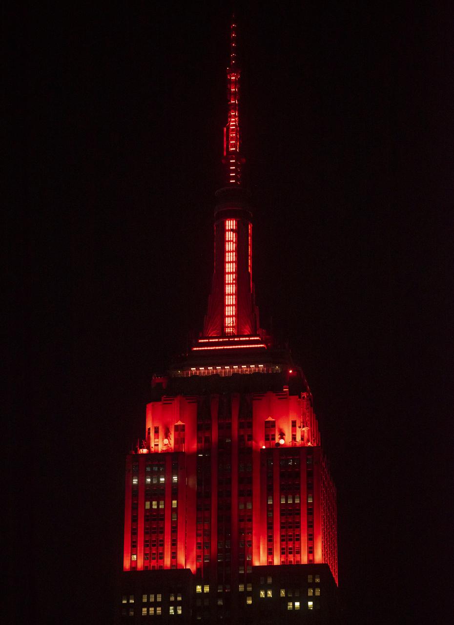 The Empire State Building is illuminated in red to celebrate this Thursday's scheduled landing on Mars of NASA's Perseverance rover, Tuesday, Feb. 16, 2021 in New York City. A key objective for Perseverance’s mission on Mars is astrobiology, including the search for signs of ancient microbial life. The rover will characterize the planet’s geology and past climate, pave the way for human exploration of the Red Planet, and be the first mission to collect and cache Martian rock and regolith. Photo Credit: (NASA/Emma Howells)