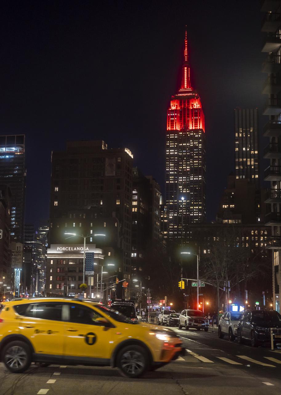 The Empire State Building is illuminated in red to celebrate this Thursday's scheduled landing on Mars of NASA's Perseverance rover, Tuesday, Feb. 16, 2021 in New York City. A key objective for Perseverance’s mission on Mars is astrobiology, including the search for signs of ancient microbial life. The rover will characterize the planet’s geology and past climate, pave the way for human exploration of the Red Planet, and be the first mission to collect and cache Martian rock and regolith. Photo Credit: (NASA/Emma Howells)
