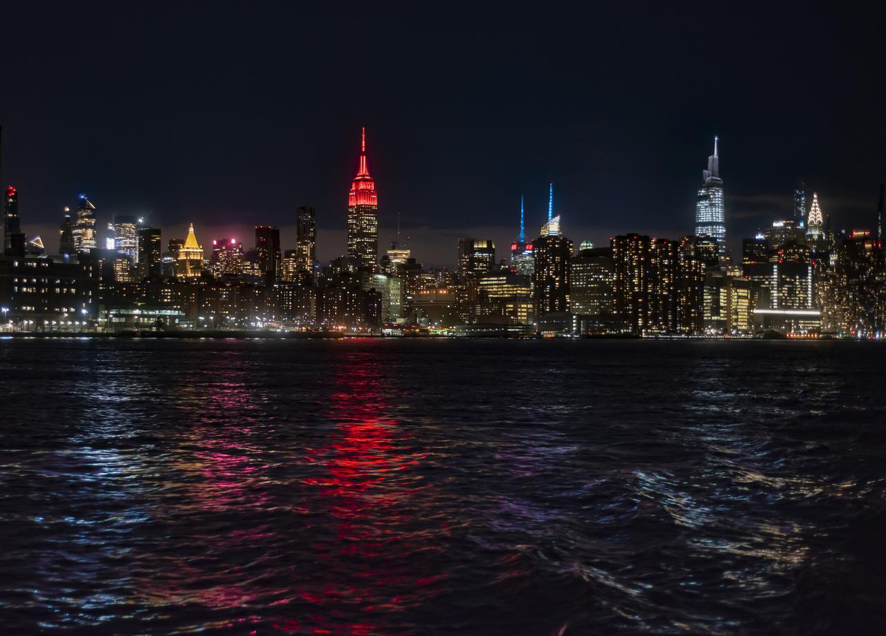 The Empire State Building is illuminated in red to celebrate this Thursday's scheduled landing on Mars of NASA's Perseverance rover, Tuesday, Feb. 16, 2021 in New York City. A key objective for Perseverance’s mission on Mars is astrobiology, including the search for signs of ancient microbial life. The rover will characterize the planet’s geology and past climate, pave the way for human exploration of the Red Planet, and be the first mission to collect and cache Martian rock and regolith. Photo Credit: (NASA/Emma Howells)