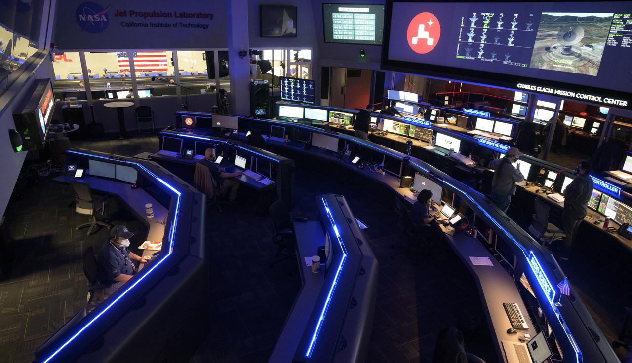 Members of NASA’s Perseverance Mars rover team study data on monitors in mission control, Thursday, Feb. 18, 2021, at NASA's Jet Propulsion Laboratory in Pasadena, California. A key objective for Perseverance’s mission on Mars is astrobiology, including the search for signs of ancient microbial life. The rover will characterize the planet’s geology and past climate, pave the way for human exploration of the Red Planet, and be the first mission to collect and cache Martian rock and regolith. Photo Credit: (NASA/Bill Ingalls)