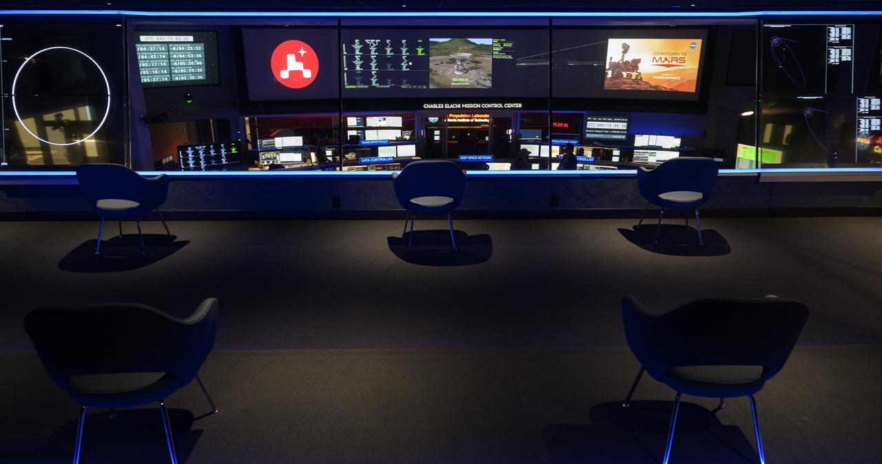 Members of NASA’s Perseverance Mars rover team study data on monitors in mission control, Thursday, Feb. 18, 2021, at NASA's Jet Propulsion Laboratory in Pasadena, California. A key objective for Perseverance’s mission on Mars is astrobiology, including the search for signs of ancient microbial life. The rover will characterize the planet’s geology and past climate, pave the way for human exploration of the Red Planet, and be the first mission to collect and cache Martian rock and regolith. Photo Credit: (NASA/Bill Ingalls)