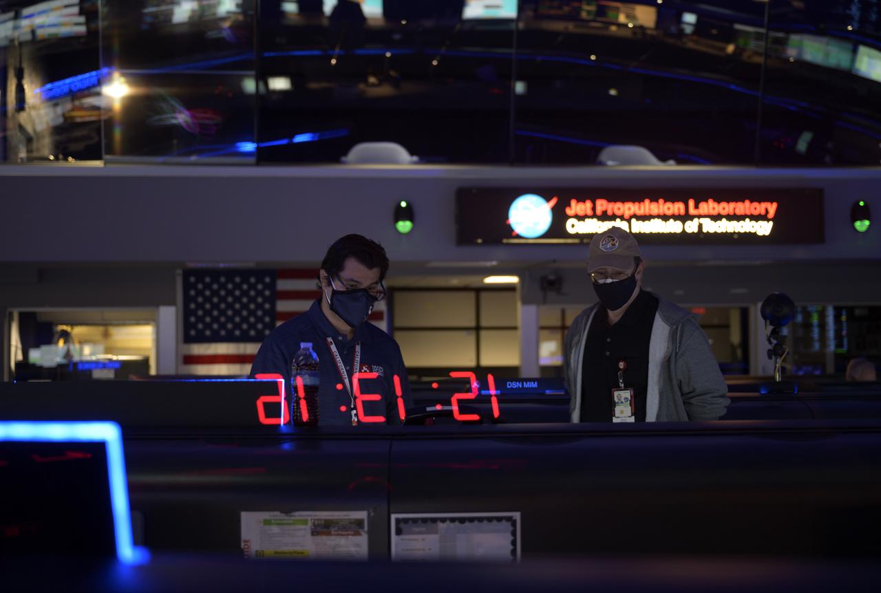 Members of NASA’s Perseverance Mars rover team study data on monitors in mission control, Thursday, Feb. 18, 2021, at NASA's Jet Propulsion Laboratory in Pasadena, California. A key objective for Perseverance’s mission on Mars is astrobiology, including the search for signs of ancient microbial life. The rover will characterize the planet’s geology and past climate, pave the way for human exploration of the Red Planet, and be the first mission to collect and cache Martian rock and regolith. Photo Credit: (NASA/Bill Ingalls)