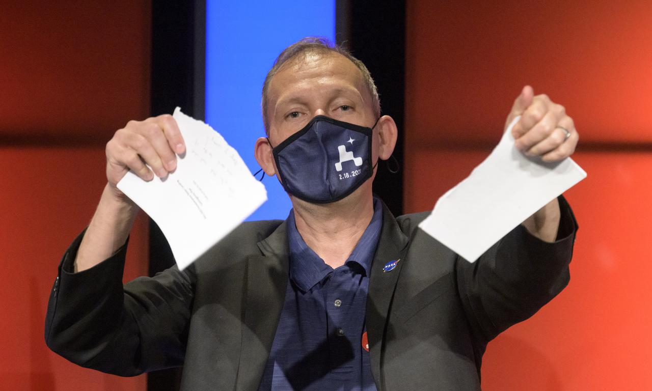 Associate Administrator of NASA's Science Mission Directorate, Thomas Zurbuchen, tears apart the contingency plan during a NASA Perseverance rover mission post-landing update, Thursday, Feb. 18, 2021, at NASA's Jet Propulsion Laboratory in Pasadena, California. A key objective for Perseverance’s mission on Mars is astrobiology, including the search for signs of ancient microbial life. The rover will characterize the planet’s geology and past climate, pave the way for human exploration of the Red Planet, and be the first mission to collect and cache Martian rock and regolith. Photo Credit: (NASA/Bill Ingalls)