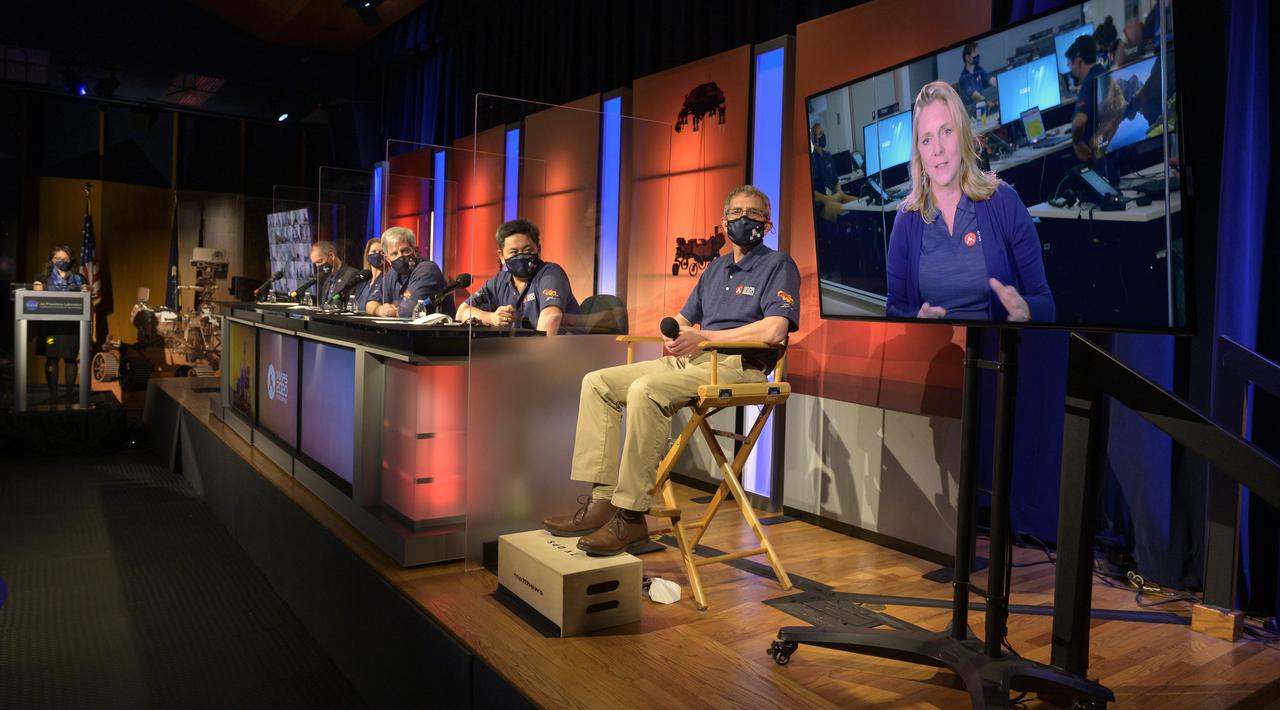 Perseverance deputy project manager, JPL, Jennifer Trosper, right monitor, gives remarks during a NASA Perseverance rover mission post-landing update, Thursday, Feb. 18, 2021, at NASA's Jet Propulsion Laboratory in Pasadena, California. A key objective for Perseverance’s mission on Mars is astrobiology, including the search for signs of ancient microbial life. The rover will characterize the planet’s geology and past climate, pave the way for human exploration of the Red Planet, and be the first mission to collect and cache Martian rock and regolith. Photo Credit: (NASA/Bill Ingalls)
