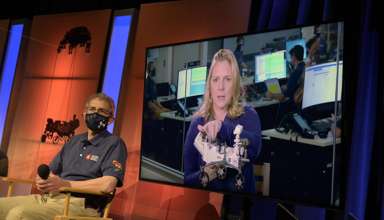 Perseverance deputy project manager, JPL, Jennifer Trosper, right monitor, gives remarks during a NASA Perseverance rover mission post-landing update, Thursday, Feb. 18, 2021, at NASA's Jet Propulsion Laboratory in Pasadena, California. A key objective for Perseverance’s mission on Mars is astrobiology, including the search for signs of ancient microbial life. The rover will characterize the planet’s geology and past climate, pave the way for human exploration of the Red Planet, and be the first mission to collect and cache Martian rock and regolith. Photo Credit: (NASA/Bill Ingalls)