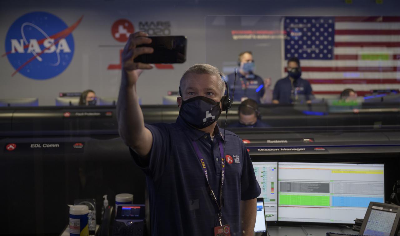 Perseverance mission manager Keith Comeaux takes a selfie as the NASA’s Perseverance Mars rover team begins to settle in to track landing in mission control, Thursday, Feb. 18, 2021, at NASA's Jet Propulsion Laboratory in Pasadena, California. A key objective for Perseverance’s mission on Mars is astrobiology, including the search for signs of ancient microbial life. The rover will characterize the planet’s geology and past climate, pave the way for human exploration of the Red Planet, and be the first mission to collect and cache Martian rock and regolith. Photo Credit: (NASA/Bill Ingalls)