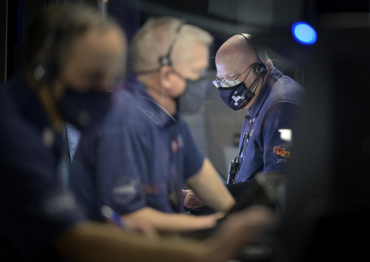 Bob Lineaweaver, right, and other members of NASA’s Perseverance Mars rover team study data on monitors in mission control, Thursday, Feb. 18, 2021, at NASA's Jet Propulsion Laboratory in Pasadena, California. A key objective for Perseverance’s mission on Mars is astrobiology, including the search for signs of ancient microbial life. The rover will characterize the planet’s geology and past climate, pave the way for human exploration of the Red Planet, and be the first mission to collect and cache Martian rock and regolith. Photo Credit: (NASA/Bill Ingalls)