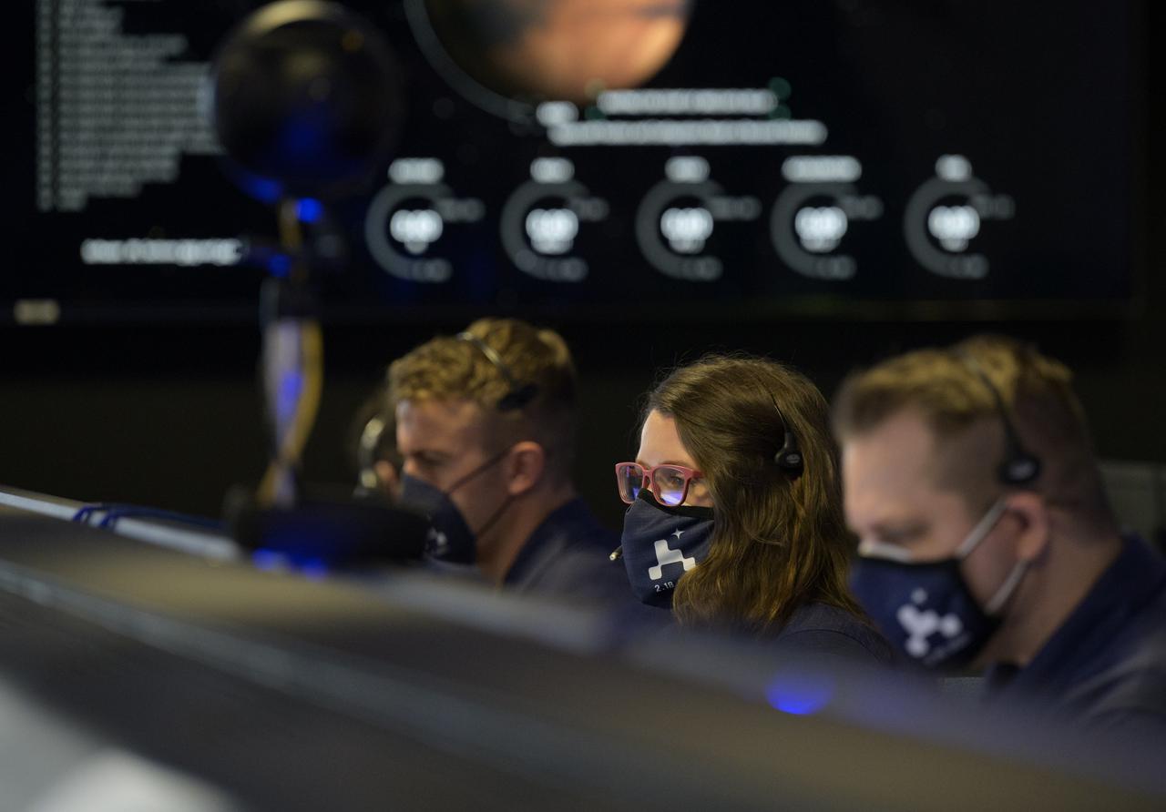 Members of NASA’s Perseverance Mars rover team study data on monitors in mission control, Thursday, Feb. 18, 2021, at NASA's Jet Propulsion Laboratory in Pasadena, California. A key objective for Perseverance’s mission on Mars is astrobiology, including the search for signs of ancient microbial life. The rover will characterize the planet’s geology and past climate, pave the way for human exploration of the Red Planet, and be the first mission to collect and cache Martian rock and regolith. Photo Credit: (NASA/Bill Ingalls)