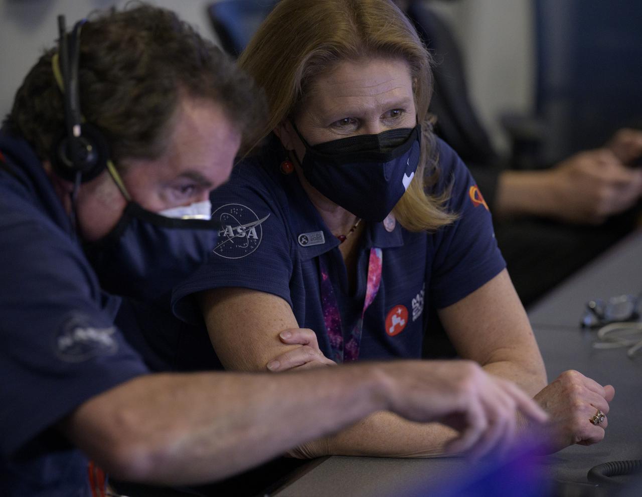 JPL Director Michael Watkins, left, talks with Director of NASA's Science Mission Directorate’s Planetary Science Division, Lori Glaze, as they and the NASA Perseverance Mars rover team await the landing of the spacecraft in mission control, Thursday, Feb. 18, 2021, at NASA's Jet Propulsion Laboratory in Pasadena, California. A key objective for Perseverance’s mission on Mars is astrobiology, including the search for signs of ancient microbial life. The rover will characterize the planet’s geology and past climate, pave the way for human exploration of the Red Planet, and be the first mission to collect and cache Martian rock and regolith. Photo Credit: (NASA/Bill Ingalls)