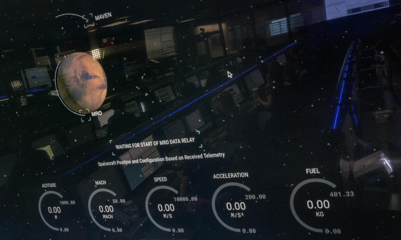 Members of NASA’s Perseverance Mars rover team are seen reflected in a monitor in mission control as they await the spacecraft’s landing on Mars, Thursday, Feb. 18, 2021, at NASA's Jet Propulsion Laboratory in Pasadena, California. A key objective for Perseverance’s mission on Mars is astrobiology, including the search for signs of ancient microbial life. The rover will characterize the planet’s geology and past climate, pave the way for human exploration of the Red Planet, and be the first mission to collect and cache Martian rock and regolith. Photo Credit: (NASA/Bill Ingalls)