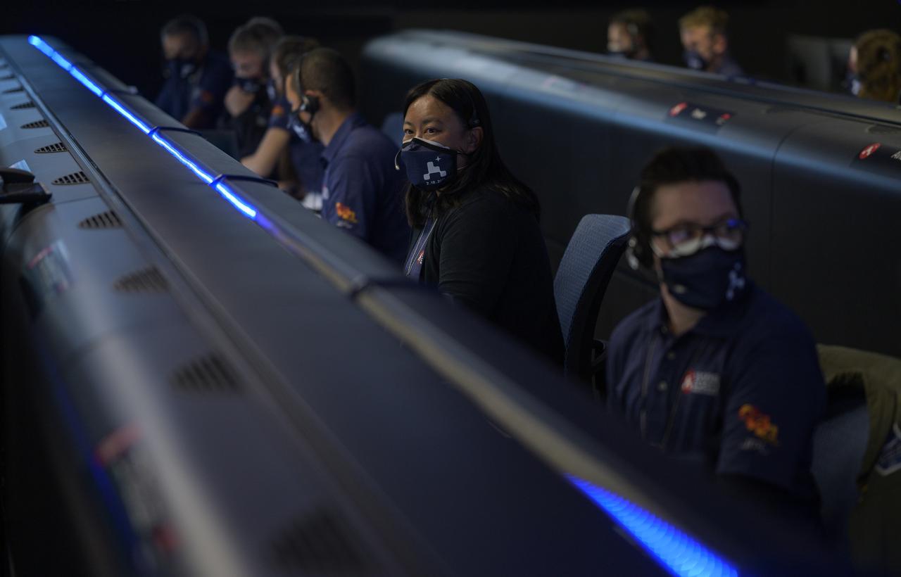 Members of NASA’s Perseverance Mars rover team study data on monitors in mission control, Thursday, Feb. 18, 2021, at NASA's Jet Propulsion Laboratory in Pasadena, California. A key objective for Perseverance’s mission on Mars is astrobiology, including the search for signs of ancient microbial life. The rover will characterize the planet’s geology and past climate, pave the way for human exploration of the Red Planet, and be the first mission to collect and cache Martian rock and regolith. Photo Credit: (NASA/Bill Ingalls)