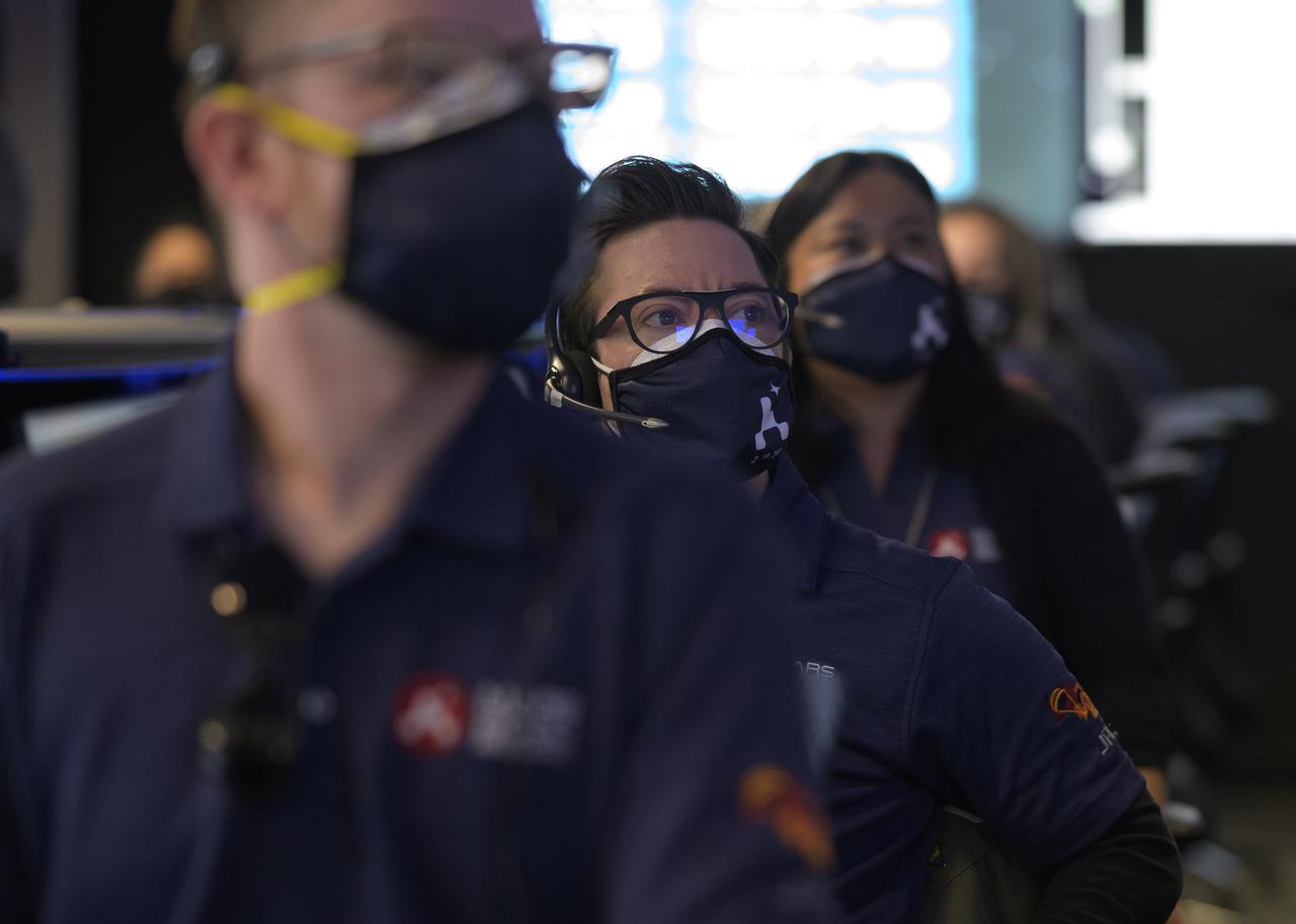 Members of NASA’s Perseverance Mars rover team study data on monitors in mission control, Thursday, Feb. 18, 2021, at NASA's Jet Propulsion Laboratory in Pasadena, California. A key objective for Perseverance’s mission on Mars is astrobiology, including the search for signs of ancient microbial life. The rover will characterize the planet’s geology and past climate, pave the way for human exploration of the Red Planet, and be the first mission to collect and cache Martian rock and regolith. Photo Credit: (NASA/Bill Ingalls)