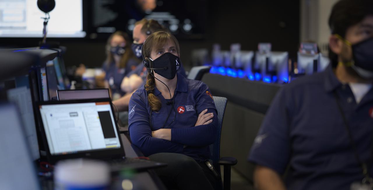 Members of NASA’s Perseverance Mars rover team study data on monitors in mission control, Thursday, Feb. 18, 2021, at NASA's Jet Propulsion Laboratory in Pasadena, California. A key objective for Perseverance’s mission on Mars is astrobiology, including the search for signs of ancient microbial life. The rover will characterize the planet’s geology and past climate, pave the way for human exploration of the Red Planet, and be the first mission to collect and cache Martian rock and regolith. Photo Credit: (NASA/Bill Ingalls)