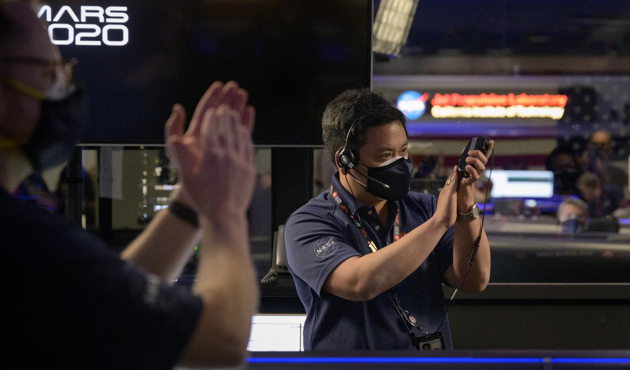Perseverance entry, descent, and landing phase lead Allen Chen and Members of NASA’s Perseverance rover team react in mission control after receiving confirmation the spacecraft successfully touched down on Mars, Thursday, Feb. 18, 2021, at NASA's Jet Propulsion Laboratory in Pasadena, California. A key objective for Perseverance’s mission on Mars is astrobiology, including the search for signs of ancient microbial life. The rover will characterize the planet’s geology and past climate, pave the way for human exploration of the Red Planet, and be the first mission to collect and cache Martian rock and regolith. Photo Credit: (NASA/Bill Ingalls)
