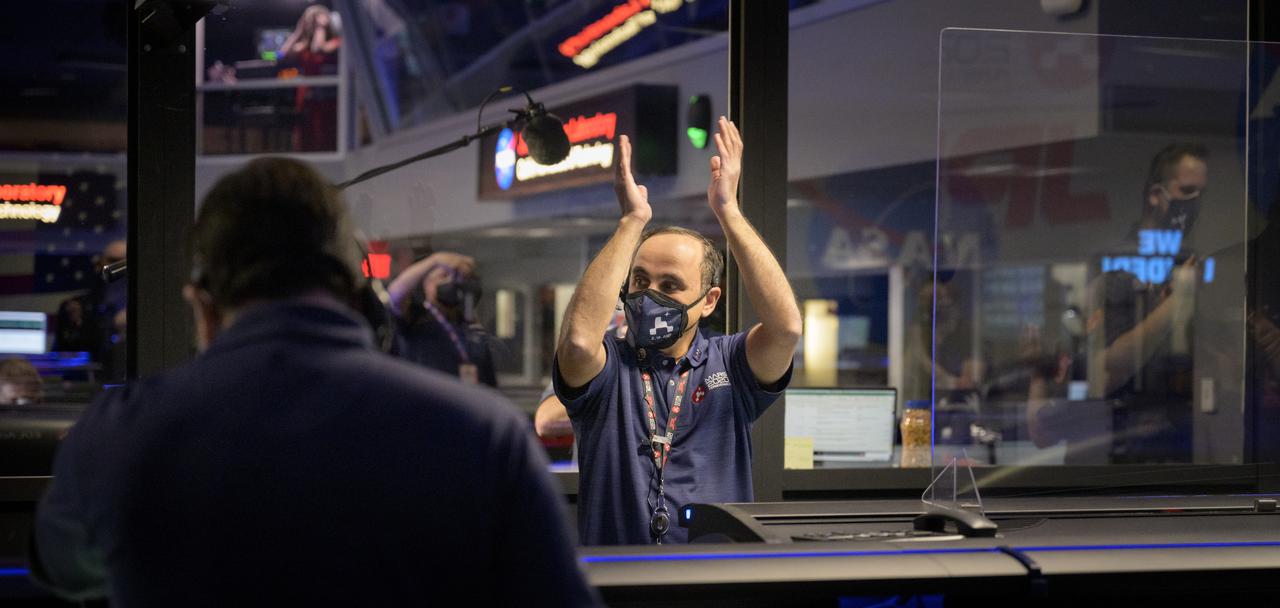 Perseverance flight director Magdy Bareh and Members of NASA’s Perseverance rover team react in mission control after receiving confirmation the spacecraft successfully touched down on Mars, Thursday, Feb. 18, 2021, at NASA's Jet Propulsion Laboratory in Pasadena, California. A key objective for Perseverance’s mission on Mars is astrobiology, including the search for signs of ancient microbial life. The rover will characterize the planet’s geology and past climate, pave the way for human exploration of the Red Planet, and be the first mission to collect and cache Martian rock and regolith. Photo Credit: (NASA/Bill Ingalls)