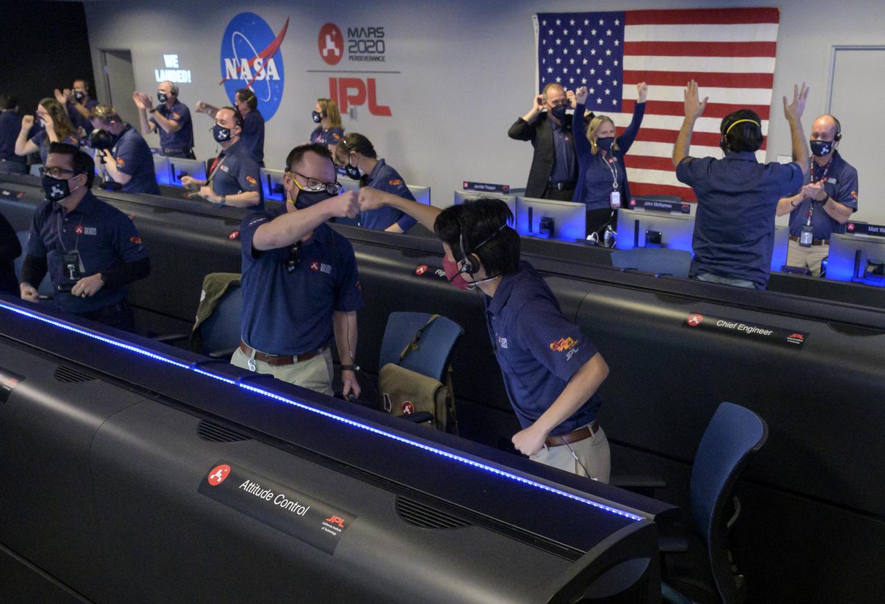 Members of NASA’s Perseverance rover team react in mission control after receiving confirmation the spacecraft successfully touched down on Mars, Thursday, Feb. 18, 2021, at NASA's Jet Propulsion Laboratory in Pasadena, California. A key objective for Perseverance’s mission on Mars is astrobiology, including the search for signs of ancient microbial life. The rover will characterize the planet’s geology and past climate, pave the way for human exploration of the Red Planet, and be the first mission to collect and cache Martian rock and regolith. Photo Credit: (NASA/Bill Ingalls)