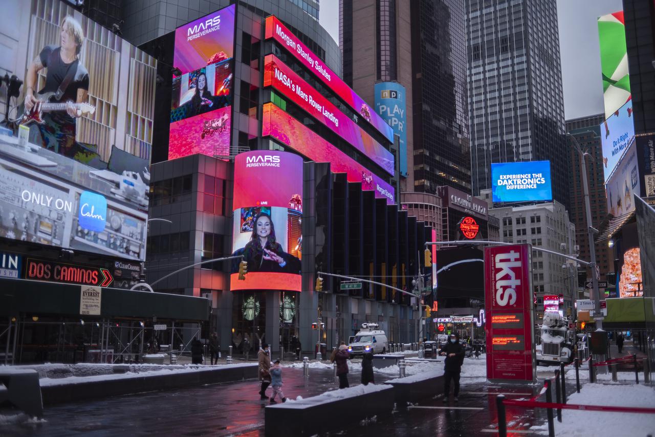 The live NASA TV broadcast from inside the Mission Support Area of NASA's Jet Propulsion Laboratory is seen on the Morgan Stanley video board as NASA's Perseverance rover begins its descent towards the surface of Mars, Thursday, Feb. 18, 2021 in New York City. A key objective for Perseverance’s mission on Mars is astrobiology, including the search for signs of ancient microbial life. The rover will characterize the planet’s geology and past climate, pave the way for human exploration of the Red Planet, and be the first mission to collect and cache Martian rock and regolith. Photo Credit: (NASA/Emma Howells)