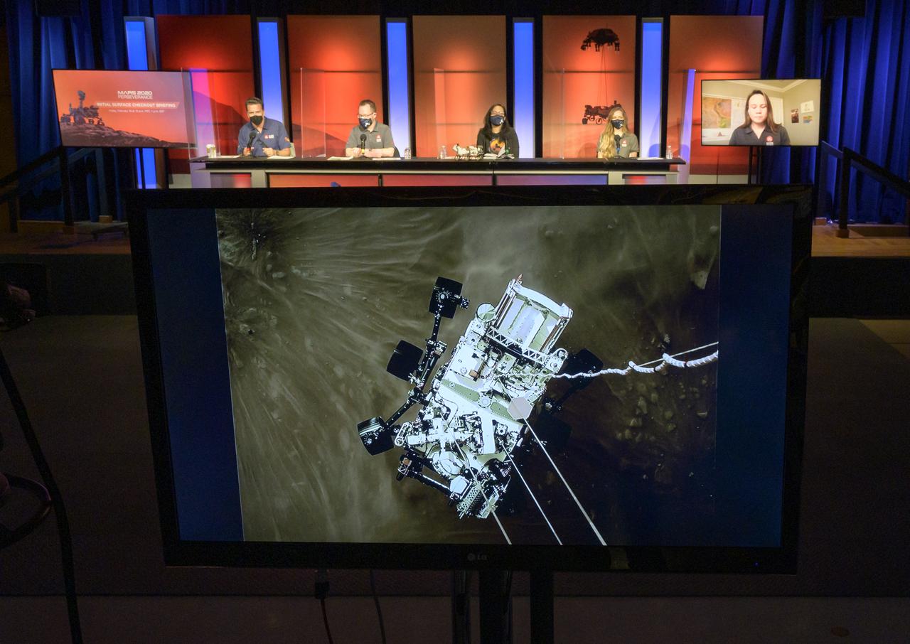 A high-resolution still image captured from cameras aboard the descent stage as NASA’s Perseverance rover touched down on Mars Feb. 18, 2021, is shown during a NASA Perseverance rover initial surface checkout briefing, Friday Feb. 19, 2021, at NASA's Jet Propulsion Laboratory in Pasadena, California. A key objective for Perseverance’s mission on Mars is astrobiology, including the search for signs of ancient microbial life. The rover will characterize the planet’s geology and past climate, pave the way for human exploration of the Red Planet, and be the first mission to collect and cache Martian rock and regolith. Photo Credit: (NASA/Bill Ingalls)
