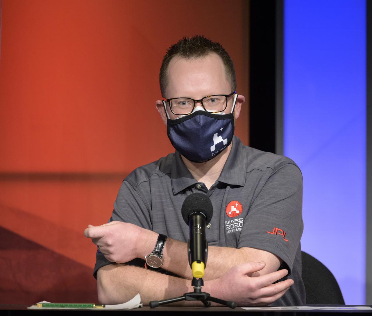 Deputy Phase Lead for Entry, Descent, and Landing Aaron Stehura, gives remarks during a NASA Perseverance rover initial surface checkout briefing, Friday Feb. 19, 2021, at NASA's Jet Propulsion Laboratory in Pasadena, California. The Perseverance Mars rover landed on Mars Thursday, Feb. 18, 2021. A key objective for Perseverance’s mission on Mars is astrobiology, including the search for signs of ancient microbial life. The rover will characterize the planet’s geology and past climate, pave the way for human exploration of the Red Planet, and be the first mission to collect and cache Martian rock and regolith. Photo Credit: (NASA/Bill Ingalls)